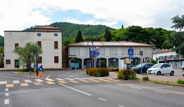 Galzignano Terme, Padua, İtalya-17 Mayıs 2025: Yeşillik, trafik işaretleri ve park halindeki arabaların yer aldığı kentsel sokak sahnesi, canlı bir toplum atmosferi sergiliyor.