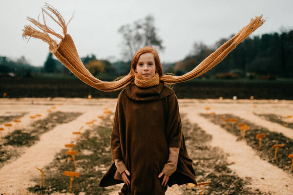 Young girl posing in the autumn park 