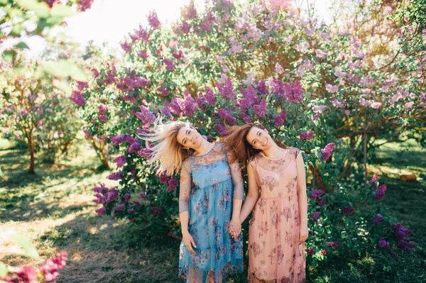 Leylak Bahçesinde Sarışın Kahverengi Saçlı Iki Güzel Kız Birlikte Vakit — Stok fotoğraf