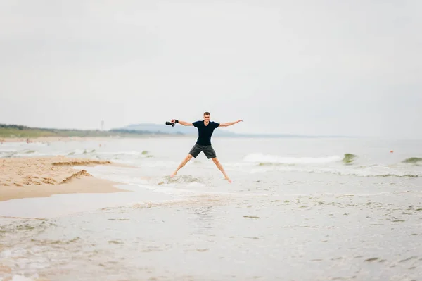 Photographer Clothes Jumping High Star Pose Sandy Beach Enjoying Sea — Zdjęcie stockowe