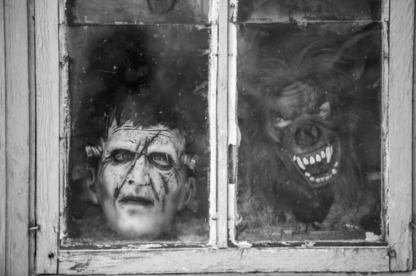 Dark vintage picture of the scary black monster face in an old cottage