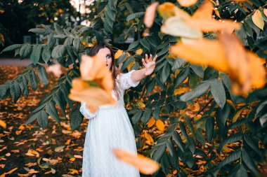 Gotik makyajlı ve komik suratlı güzel bir kız yaz parkında poz veriyor. 