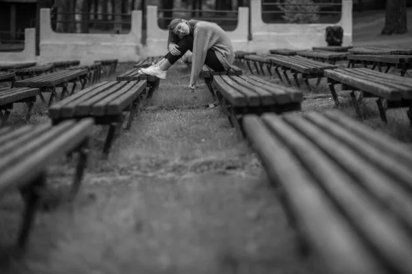 Одинокий Грустный Подросток Сидящий Один Скамейке Парке Несколькими Рядами Пустынных — стоковое фото