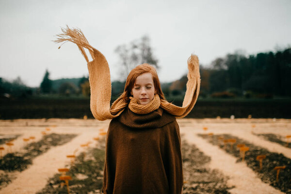 Young girl posing in the autumn park 