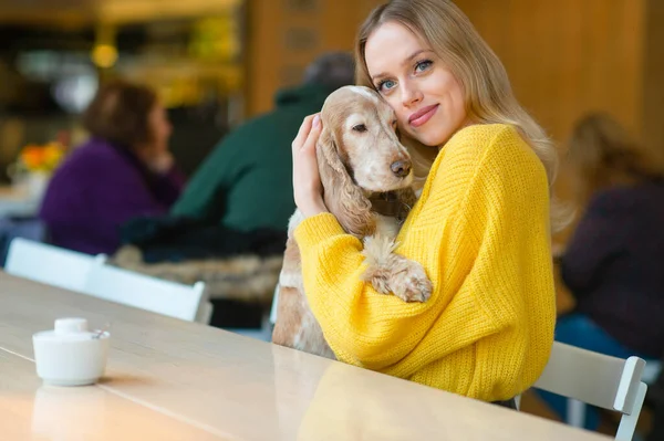 Feliz Joven Rubia Suéter Amarillo Sentada Mesa Caffe Abrazando Adorable —  Fotos de Stock