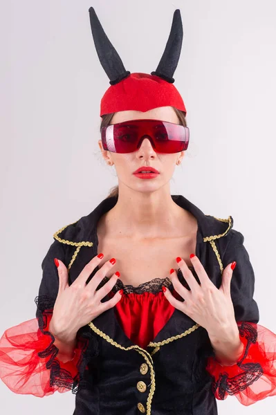 スタジオファッションポートレートの魅力セクシーな女性で未来的な眼鏡 黒赤カーニバルの衣装と悪魔の角彼女の頭 — ストック写真