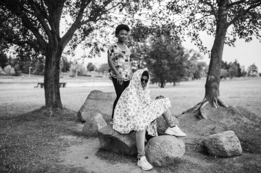 Parkta taşlara poz veren tuhaf esmer bir çift. 