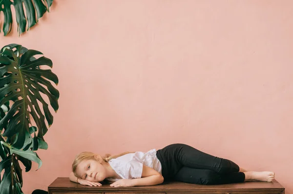 Lonely Little Girl Pensive Tranquil Face Lying Wooden Surface Home — Stock Photo, Image