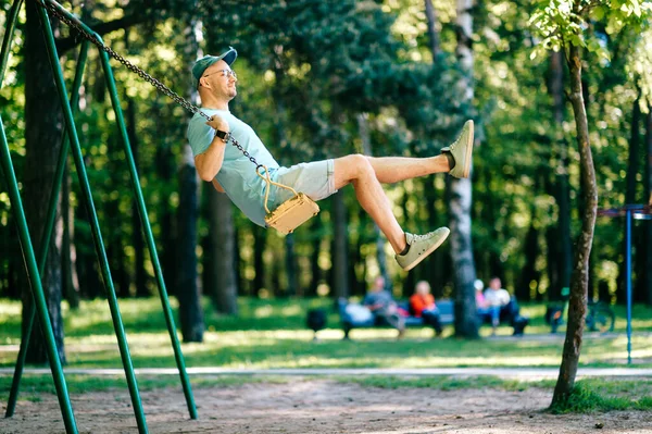 Adult Stylish Man Glasses Riding Swing City Park Playground Children — Stock Photo, Image