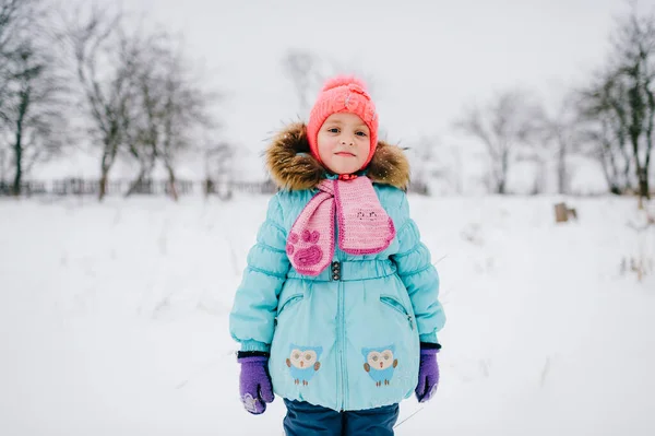 Positives Kleines Mädchen Das Verschneiten Feld Steht Und Die Kamera — Stockfoto