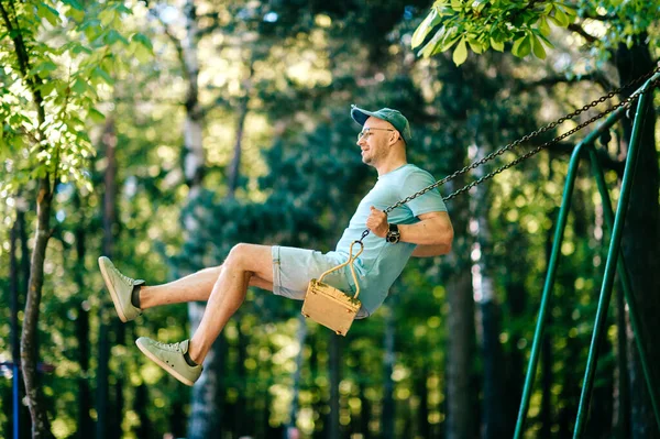 Adult Stylish Man Glasses Riding Swing City Park Playground Children — Stock Photo, Image