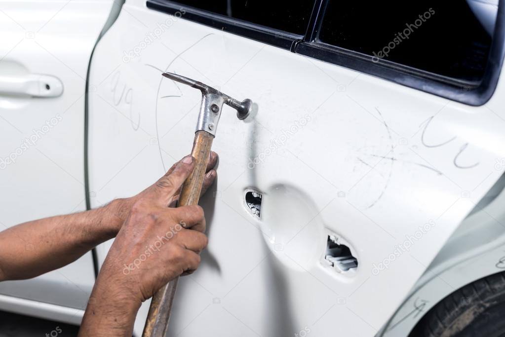 Auto Body Repair Series Mechanic Fixing Dented Car Door Stock