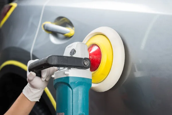 Car detailing series : Worker waxing grey car — Stock Photo, Image
