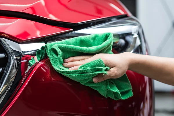 Car detailing series : Worker cleaning red car — Stock Photo, Image
