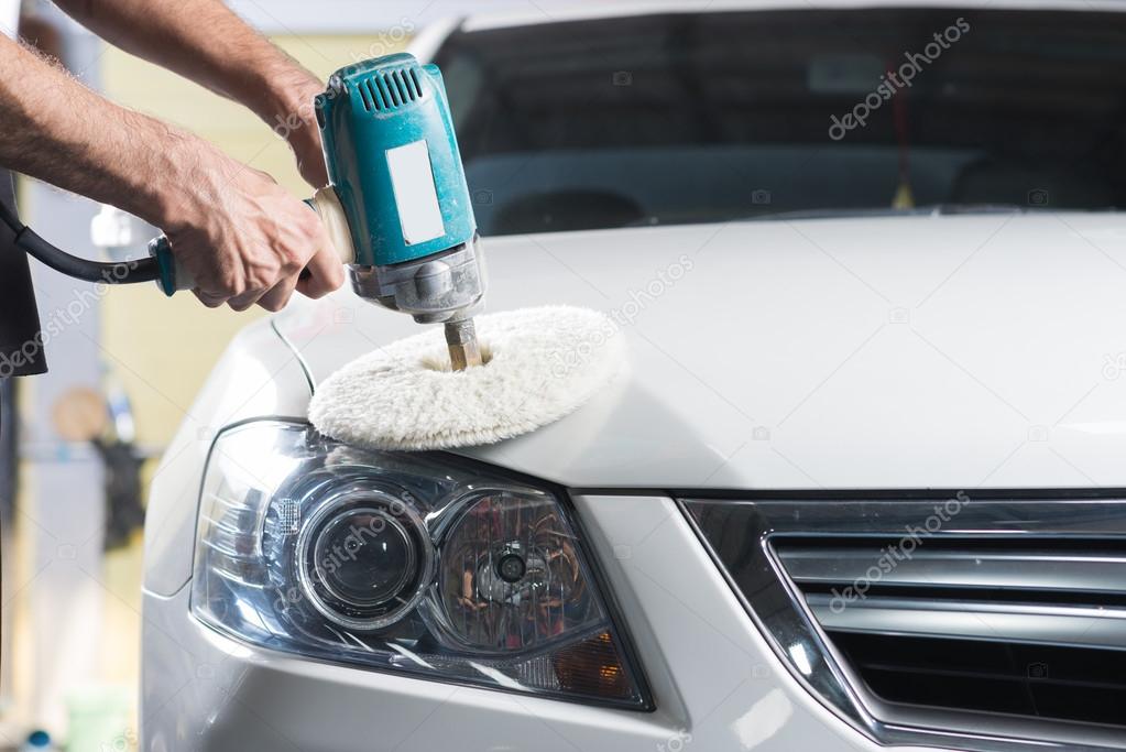 Car detailing series : Worker polishing white car