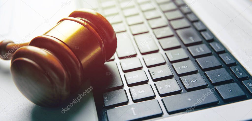 Close up view of a hammer and a computer keyboard.