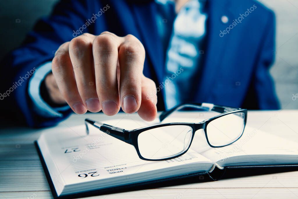 businessman going to take glasses to read