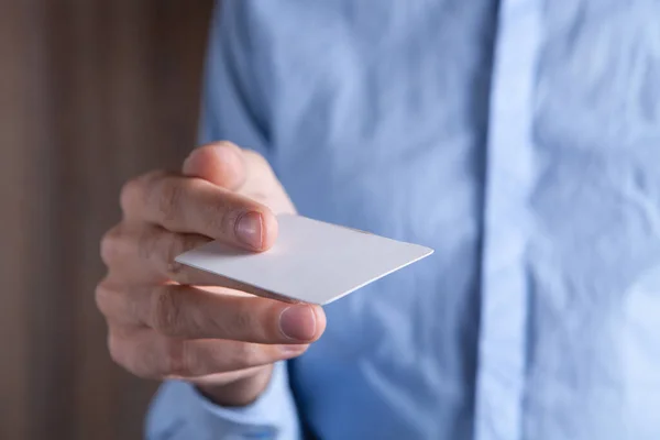young man gives a business card