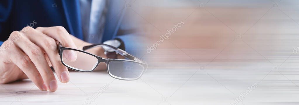 businessman going to take glasses to read