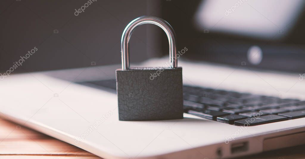 Lock on laptop as computer protection and cyber safety