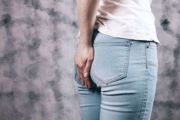 the girl has hemorrhoids. feeling of pain