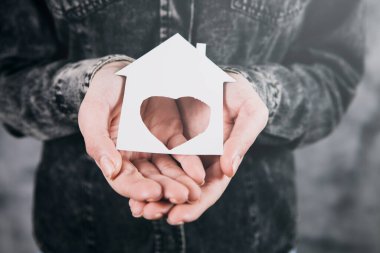 Sıcak ve rahat minyatür ev kadınların elinde. Sevgi ve şefkat.