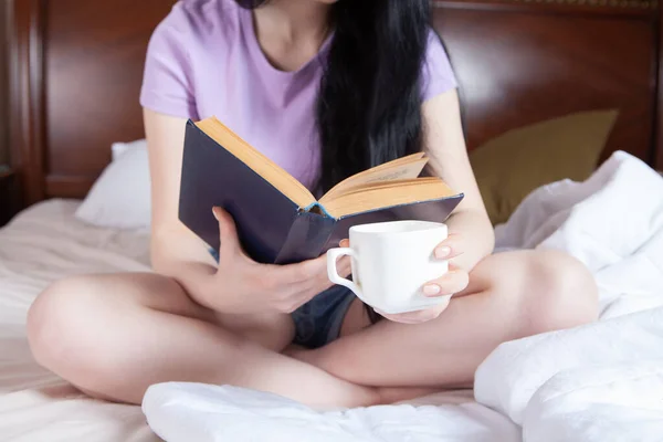 Young Girl Lying Bed Drinks Mug Reads Book Day — Stock Photo, Image