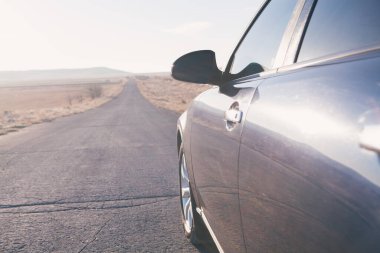 Araba tarlaların yanındaki yolda.