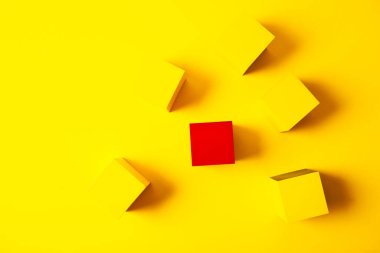 Sarı arka planda izole edilmiş kırmızı ve sarı tahta küpler. Üst görünüm.