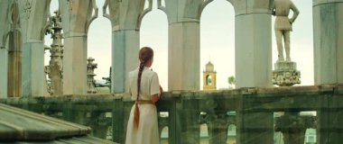 Kadın, öğleden sonra gökyüzünün altında katedral terasından Milan 'ın çatı manzarasının keyfini çıkarıyor..