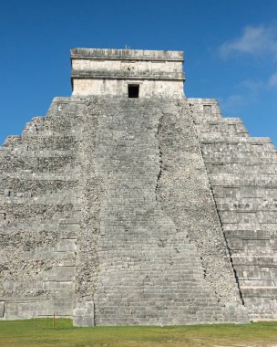 Kukulcan Tapınağı olarak da bilinen ikonik El Castillo Piramidi, Meksika 'daki Chichen Itza' da antik Maya mimarisini sergileyen canlı mavi gökyüzüne karşı görkemli bir şekilde duruyor..