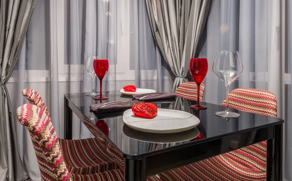 Kırmızı Şarap Kadehleri, Dekoratif Tatlı Tabakları ve Şık Sandalyeler, Çağdaş Ev Dekoru ve Yumuşak Perde Arkaplanlı Konforlu Akşam Yemeği Masası