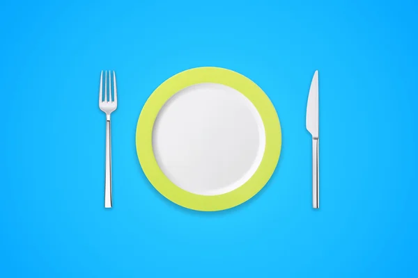 Tallrik med gaffel och kniv på blå bakgrund — Stockfoto