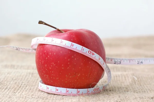 Apple and meter on the gunny cloth — Stock Photo, Image