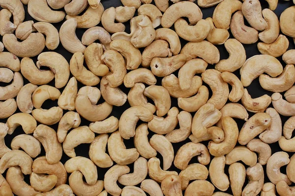 Background from cashew nuts on the black background