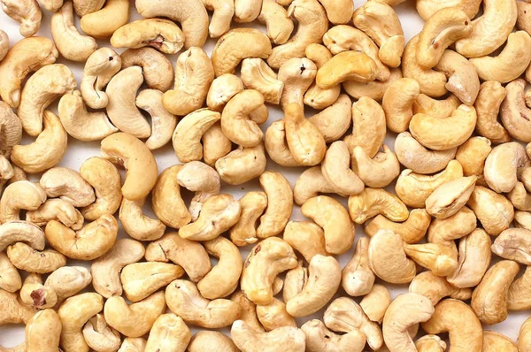 Hintergrund aus Cashewnüssen auf weißem Hintergrund — Stockfoto