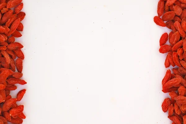 Frame of Chinese goji on short sides on the white background — Stock Photo, Image