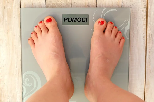 Feet on scale with text help in English language — Stock Photo, Image