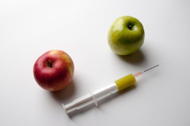 Şırınga ile yeşil ve Kırmızı elma. GDO