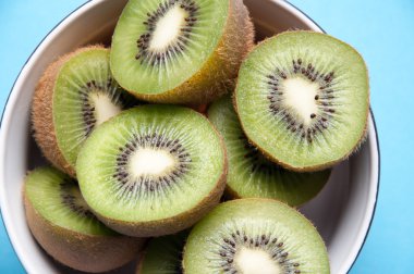 Kivi kupa mavi zemin üzerine dilim yukarıdan izlendi