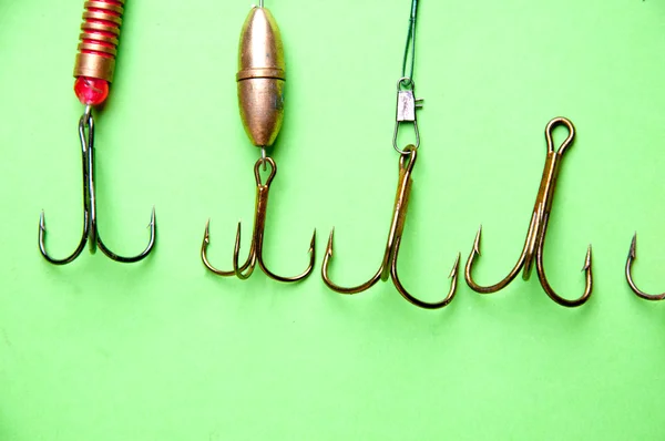 Fishing hooks on a green backgound — Stock Photo, Image