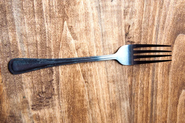 Fork on a wooden table — Stock Photo, Image