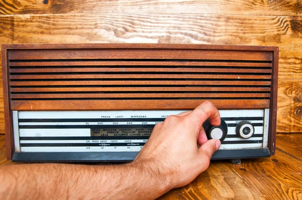 Hand tuned old radio. wooden background