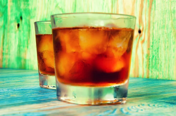 Glass of whiskey on a abstract wooden table — Stock Photo, Image