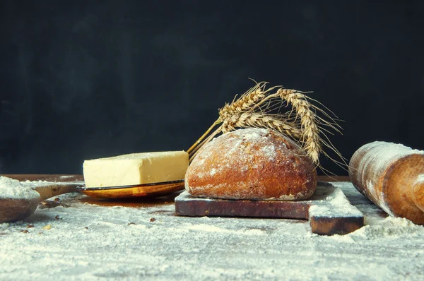 Bread and additions on a wooden table — Stock Photo, Image