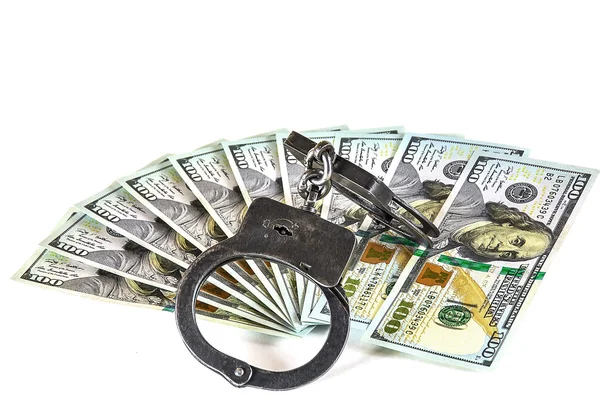 100 dollar bills lay fan and metal handcuffs — Stock Photo, Image