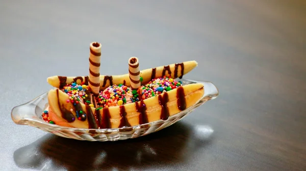 Banana Split, banana with ice cream wafer tubes and colored dragee.