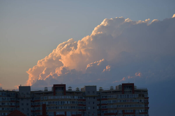 cloud over building in sunset colors