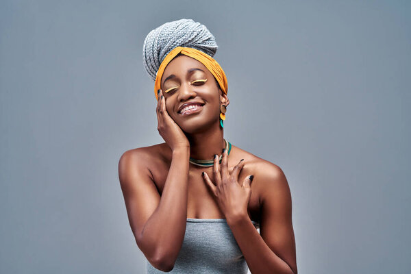Young sensual african american woman with artistic make-up dreaming isolated on grey background. Copy space