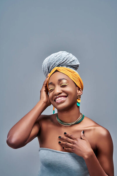 Portrait of young african american woman smiling with closed eyes. Vertical photo